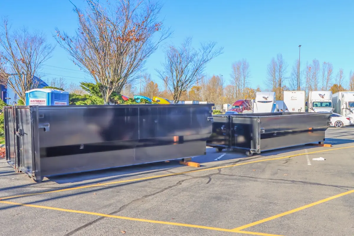 Professional dumpster rental service with roll-off container on residential driveway in Moberly